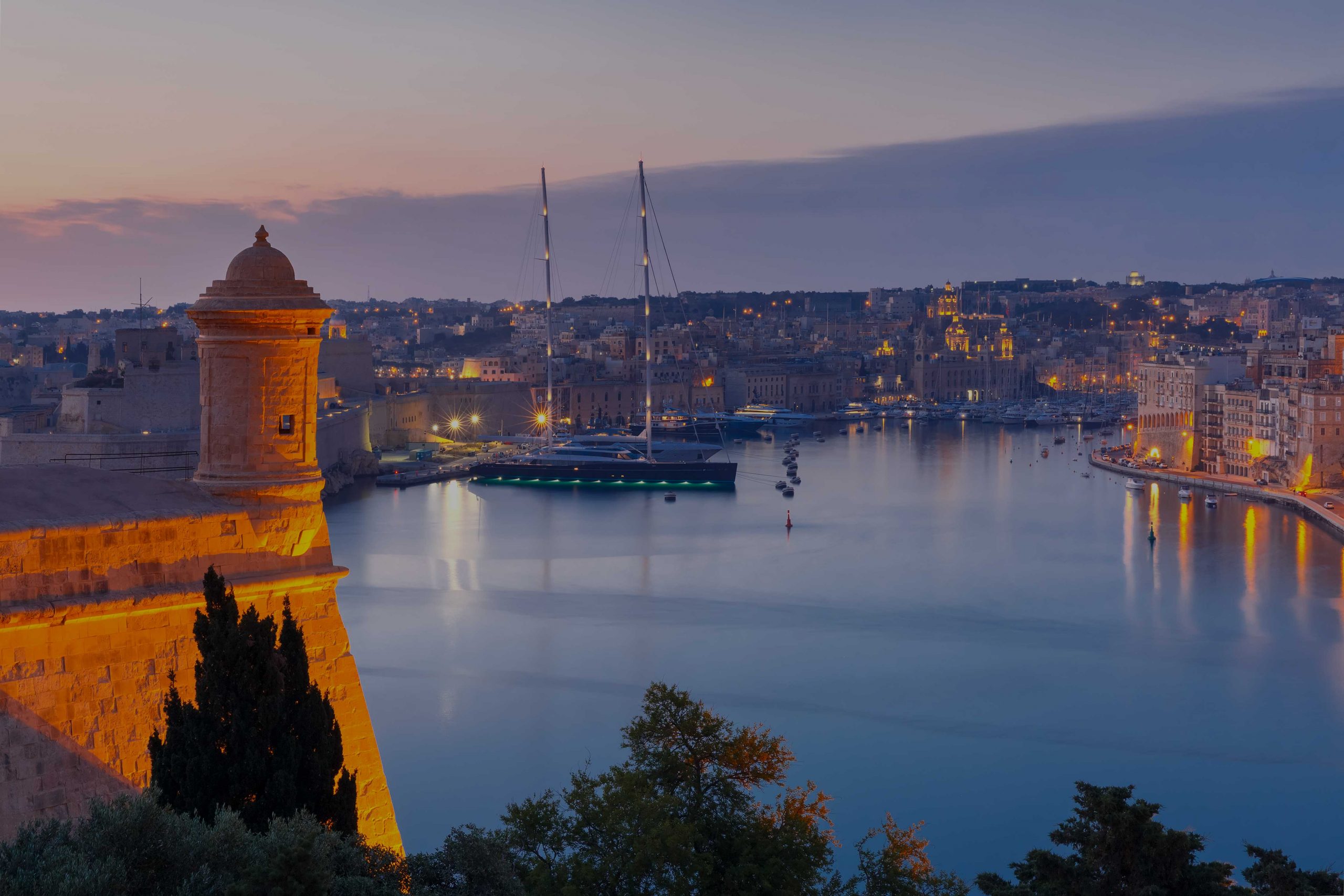 aerial-skyline-view-birgu-grand-harbor-with-ships-as-seen-from-valletta-during-morning-blue-hour-malta